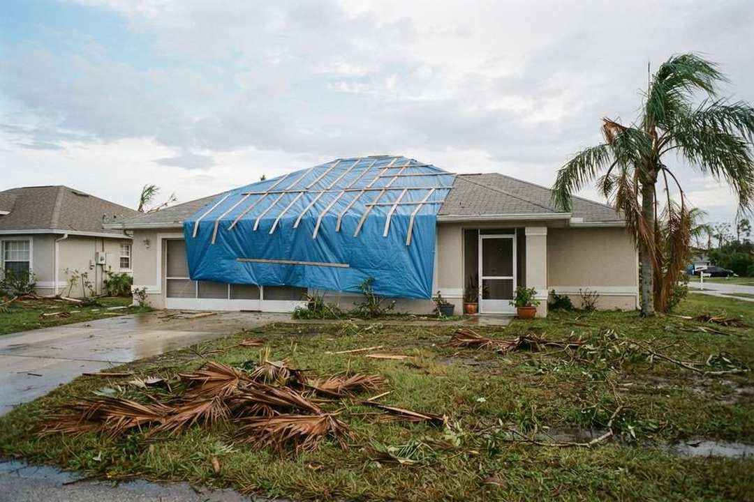 Blue emergency tarp secured on a storm-damaged Florida roof